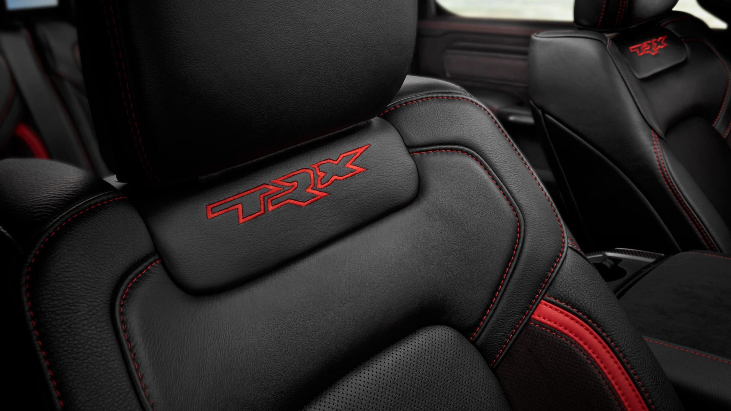 Command the cabin from performance-bolstered front bucket seats featuring a TRX-specific embroidered logo and accent stitching in red needlework.