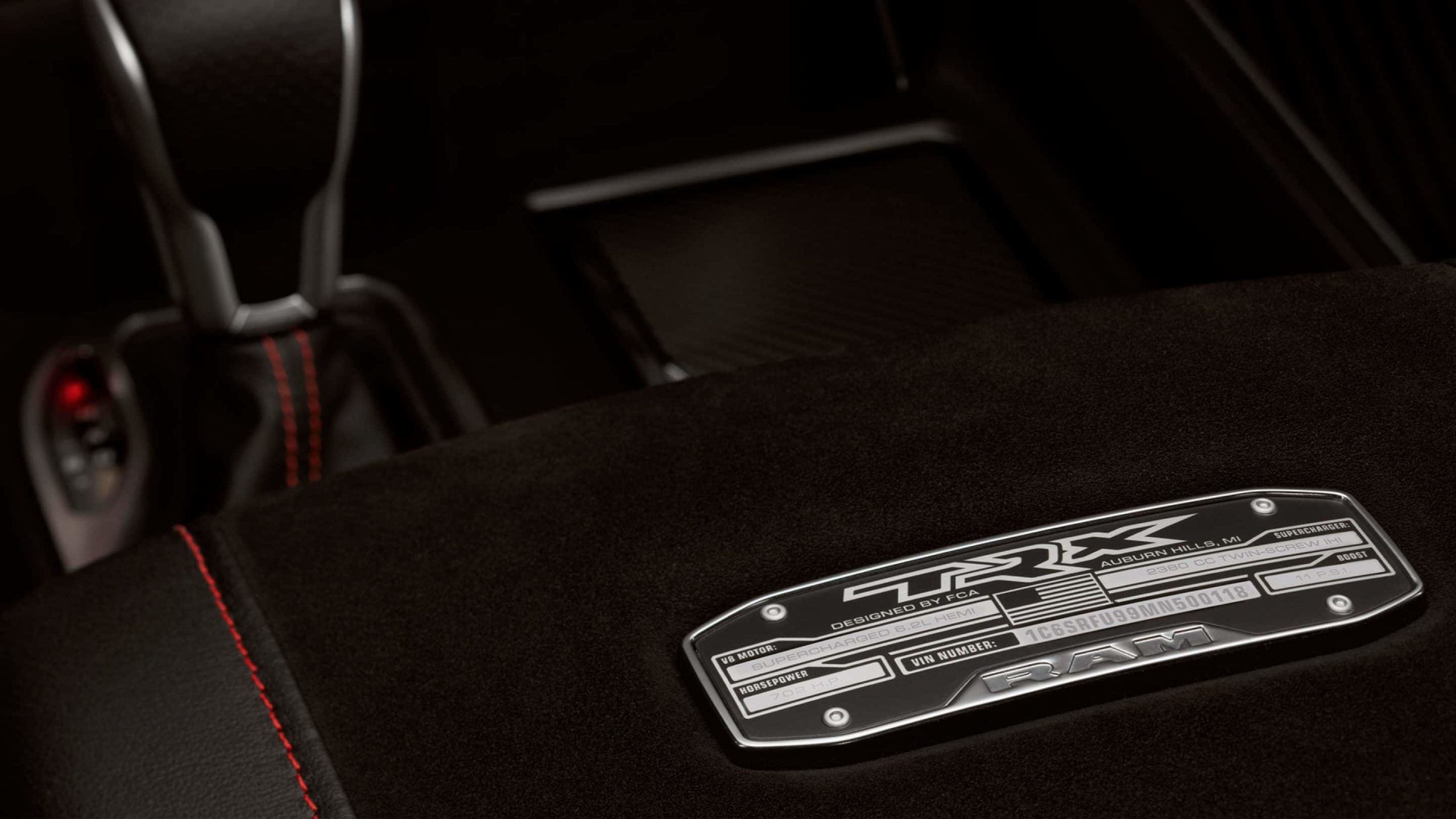 The 2021 Ram 1500 TRX features an elevated interior with details like a console armrest-positioned specification plate that displays stats like horsepower, PSI and the Vehicle Identification Number (VIN) that is unique to each TRX.